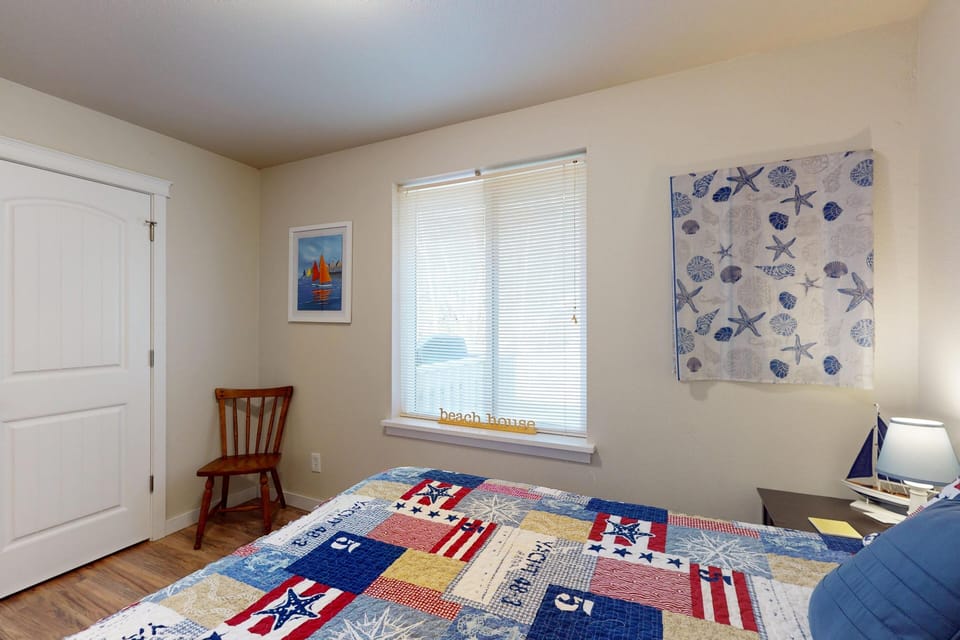 Cozy bedroom retreat with natural light and charming beach-themed accents.