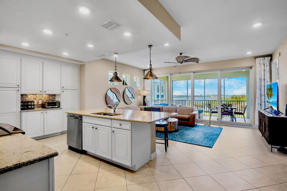 Open-concept living area with kitchen island and screened lanai