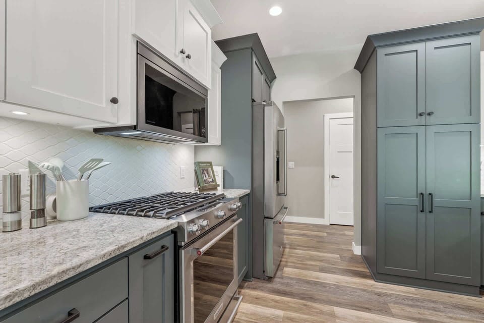 Your fully equipped kitchen blends style and function with sleek stainless appliances, custom cabinetry, and elegant tile backsplash—perfect for preparing memorable meals.