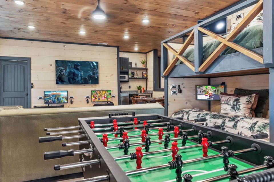 Challenge friends to foosball while cozy bunk beds await after your gaming sessions in this rustic entertainment haven.