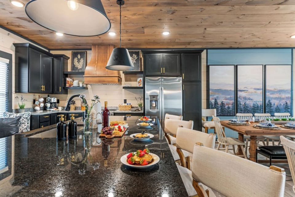 Your gourmet kitchen awaits with sleek granite counters, premium appliances, and breathtaking mountain views through huge windows.