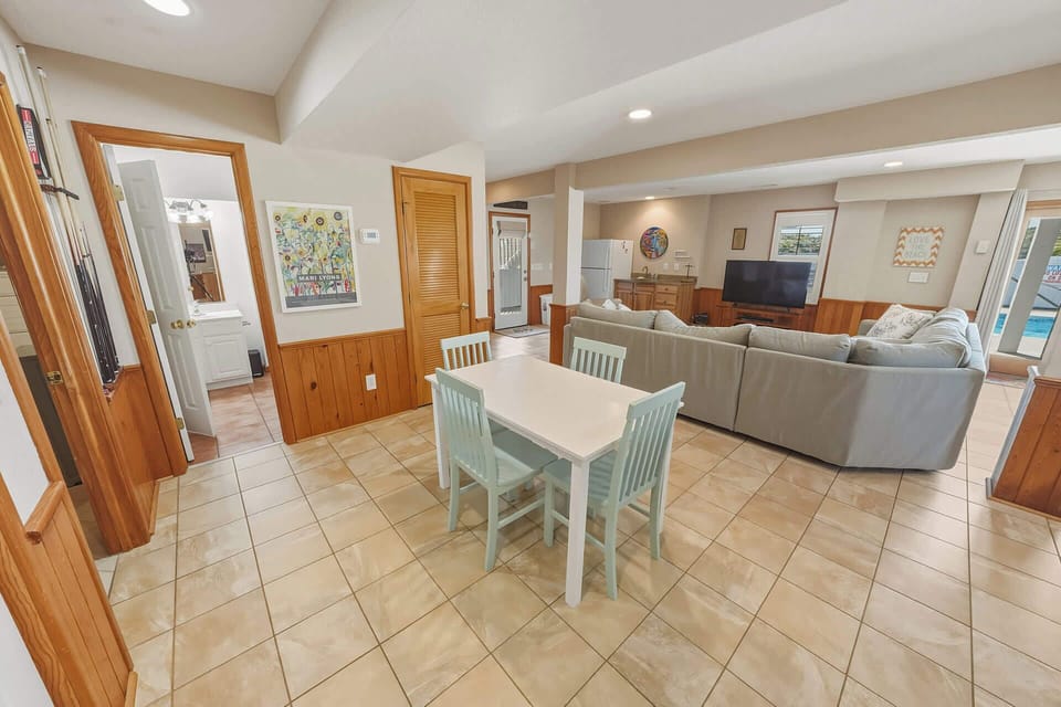 Ground Level: Rec Room with Sectional Seating, Billiards, Wet Bar, TV and Pool Area Access