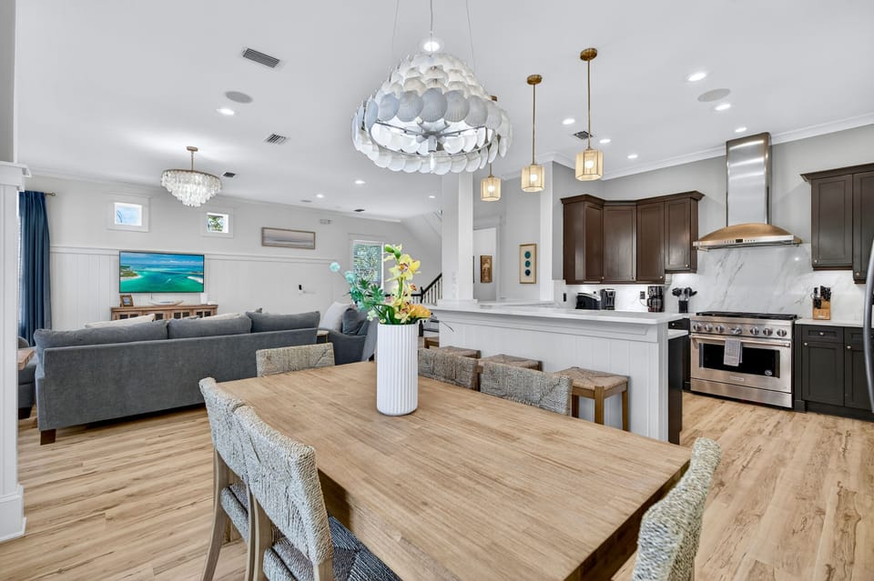 2nd Floor - Open-concept dining space with seating for 6 at the dining table, 5 at the kitchen island, plus outdoor dining for 4 on the covered balcony—perfect for family dinners and group gatherings at Sugar Palm.