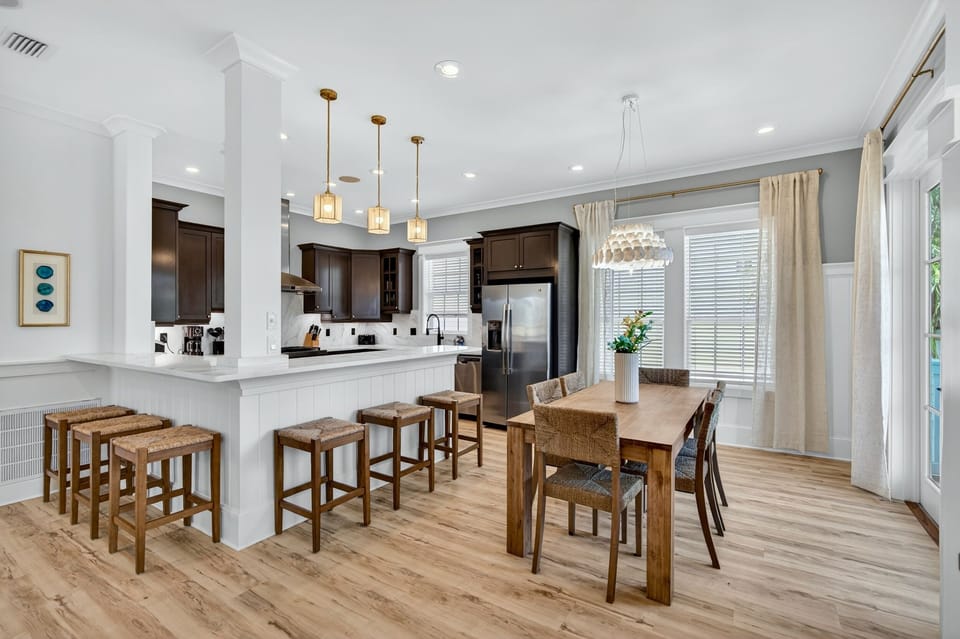2nd Floor - Open-concept dining space with seating for 6 at the dining table, 5 at the kitchen island, plus outdoor dining for 4 on the covered balcony—perfect for family dinners and group gatherings at Sugar Palm.
