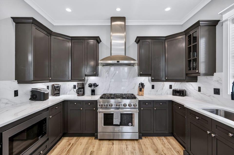 2nd Floor - Fully stocked gourmet chef’s kitchen with quartz countertops, stainless steel appliances, oversized island seating for 5, and everything needed for family meals, entertaining, and unforgettable group vacations in Miramar Beach.