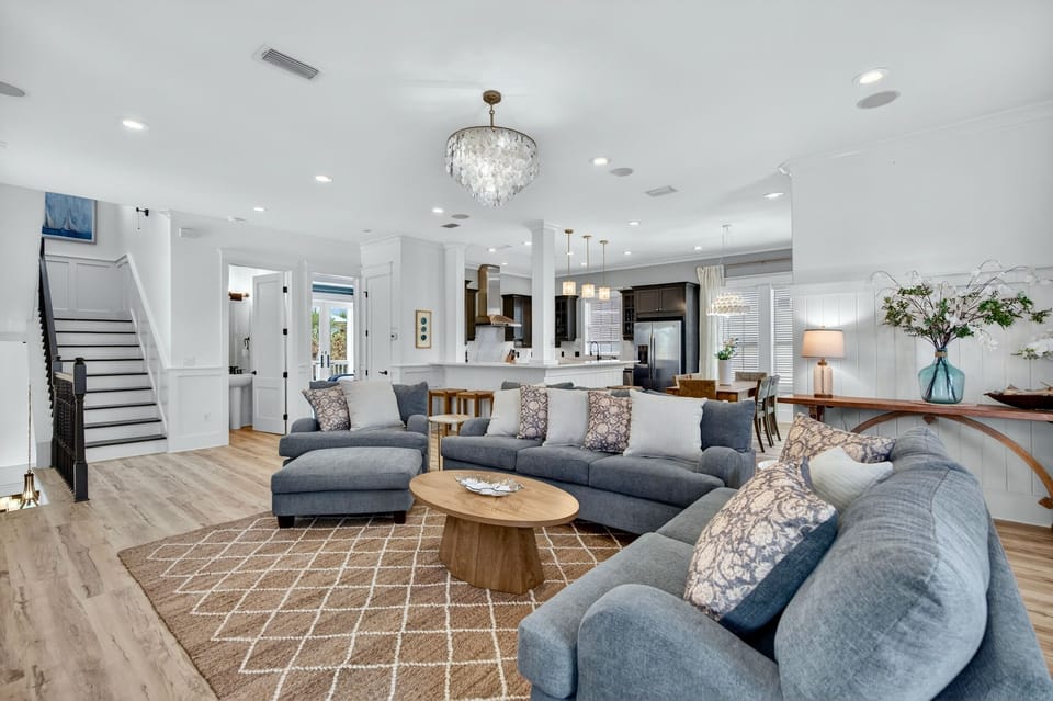 2nd Floor - Bright and spacious living room with oversized seating, 75” 4K Smart TV, and open-concept design—perfect for movie nights, relaxing after the beach, and gathering with family and friends at Sugar Palm.