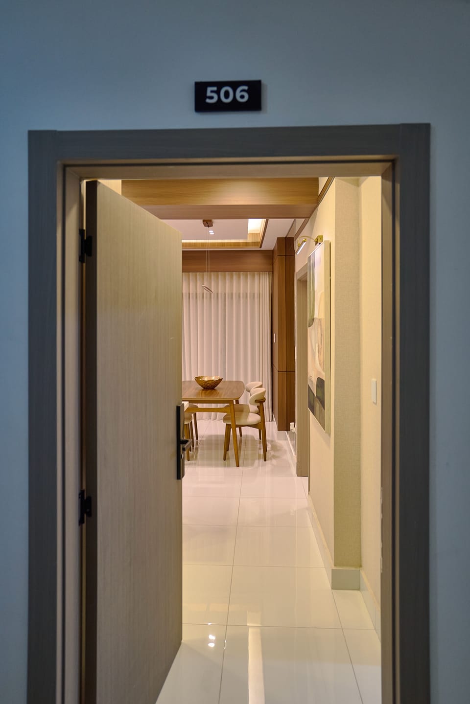 Inviting dining room with elegant wooden table and soft lighting for a cozy meal experience.