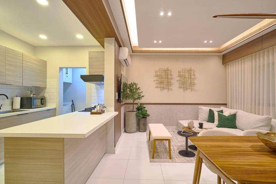 Open-plan kitchen and living area with sleek modern design and cozy seating.