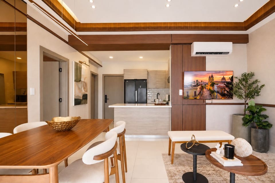 Open-plan living and dining area with modern decor and a sleek kitchen island.