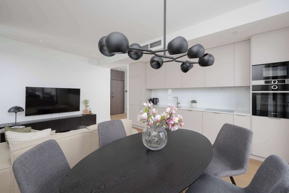 Spacious open-concept living and dining area enhanced by artistic décor and abundant daylight.