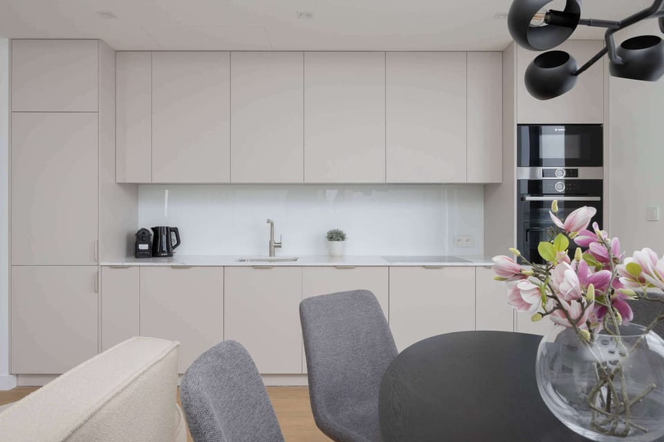 Bright dining and kitchen space combining functionality with stylish contemporary design details.