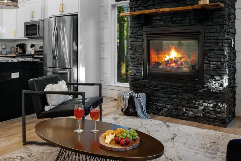 Relaxed indoor space built for connection, with cozy furnishings and a warm fireplace glow.