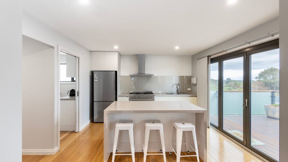 Large central kitchen with island bench and breakfast bar seating