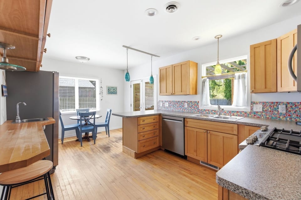 Open layout kitchen with dining area and ample counter space for cooking and gathering.