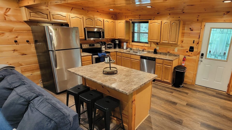 Cozy cabin kitchen with island seating and modern stainless appliances