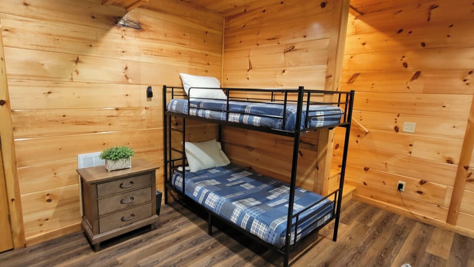 Cozy wood-paneled bunk room perfect for kids or extra guests