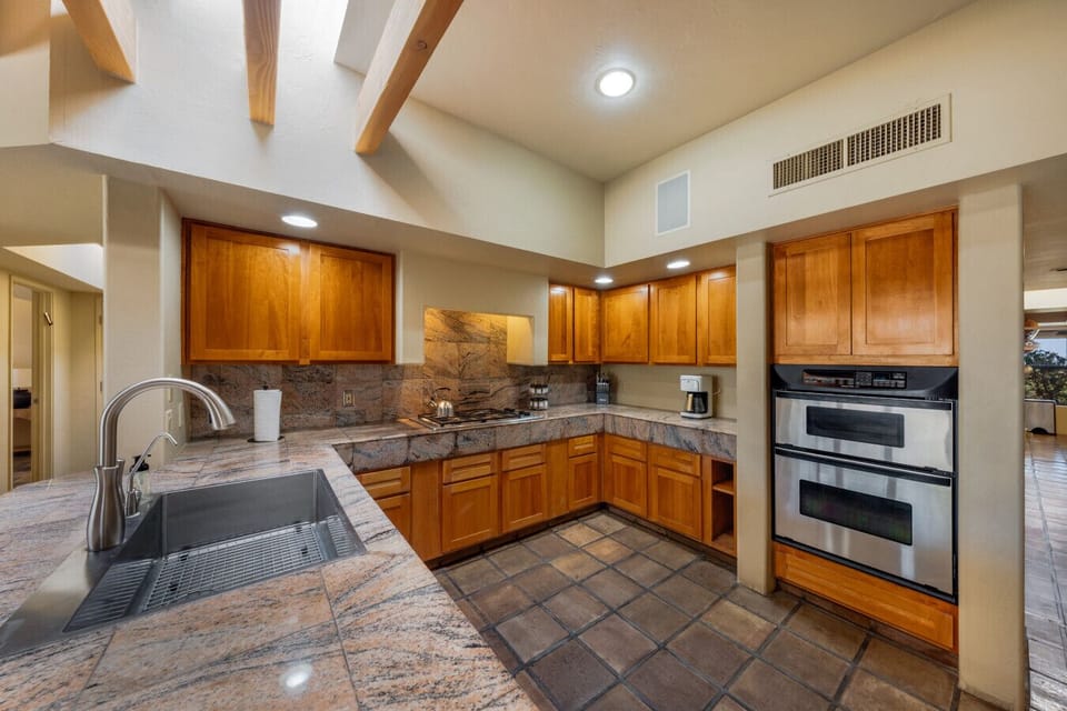 Gas cooktop, oven, microwave, and ample counter space make cooking for a group easy