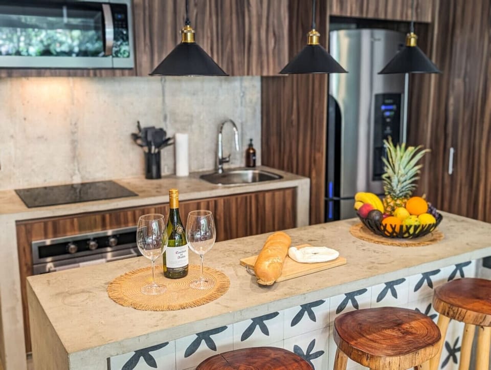 Prepare your favorite meals in the contemporary kitchen featuring sleek finishes, ample space, and a welcoming breakfast bar.
