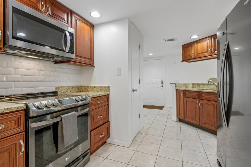 Modern kitchen with stainless appliances and generous storage