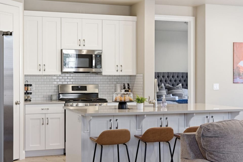 Gourmet Kitchen: Cook up a storm in this sleek, stylish space with modern appliances and chic seating!