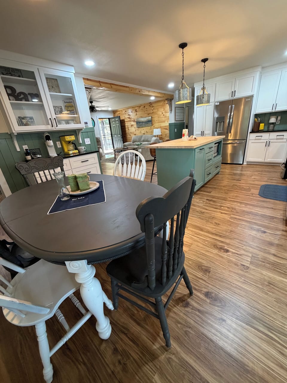Dining area with view into kitchen and living room