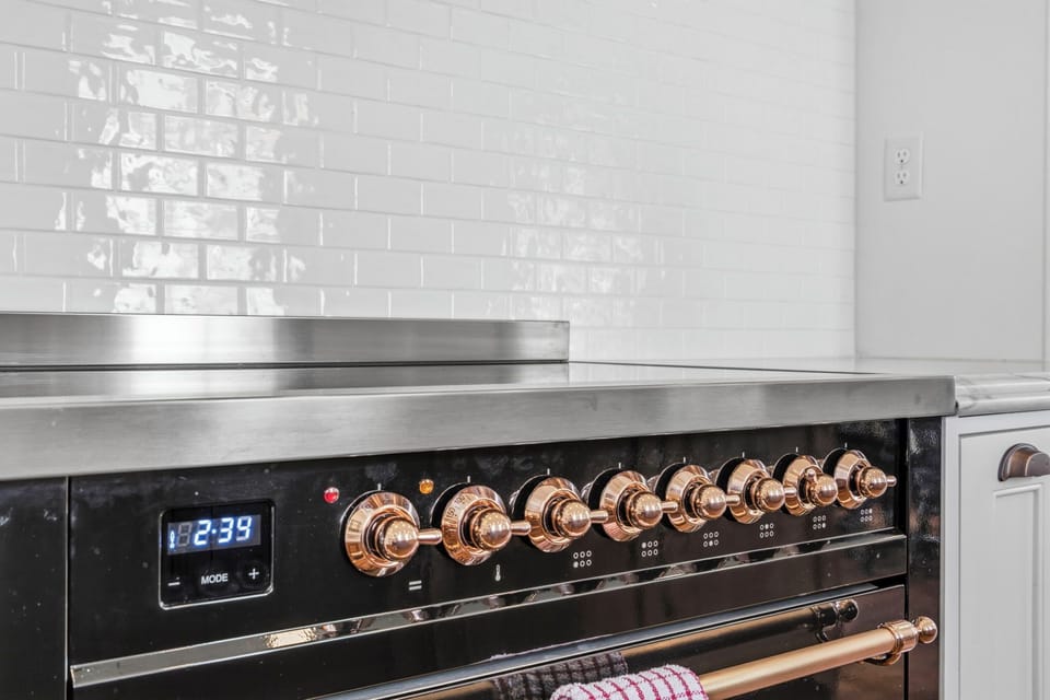 High-end range with sleek finishes and statement gold accents, perfect for cooking in style.