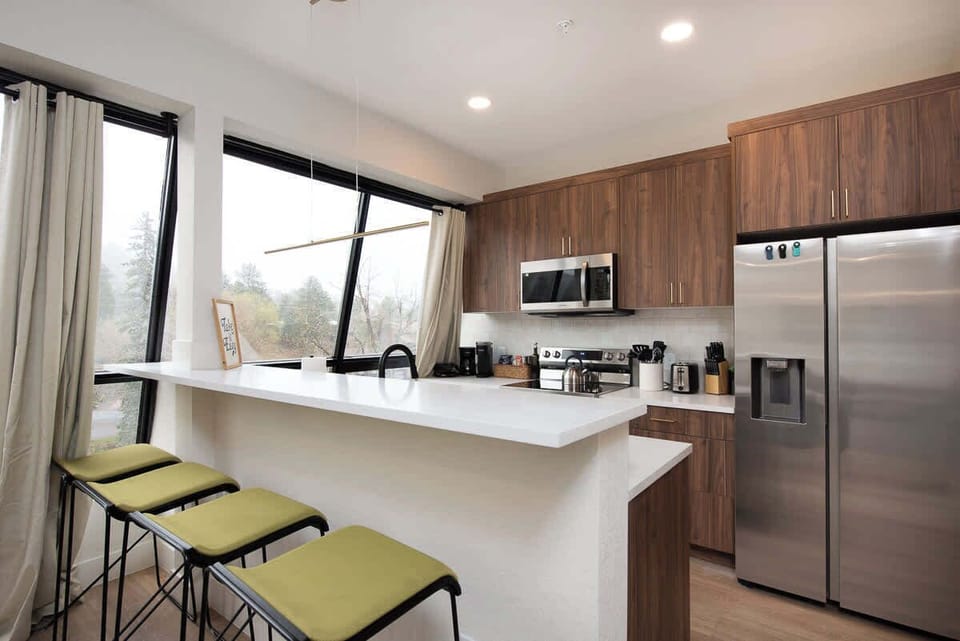 The open kitchen with breakfast bar is perfect for an enjoyable meal.
