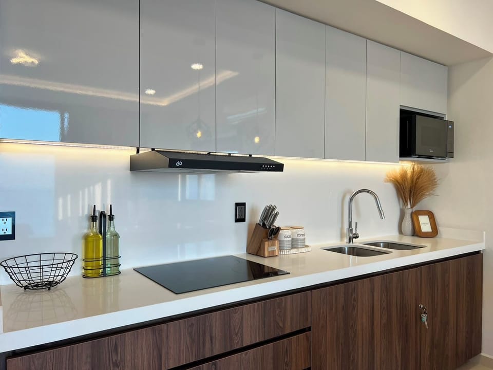 Deluxe Suite, Balcony, Beach View | Private kitchen | Mini-fridge, microwave, cookware/dishes/utensils, dining table