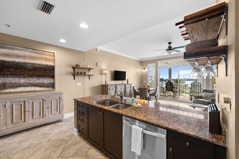 The fully equipped kitchen features granite countertops, stainless-steel appliances, and has everything you need to prepare meals for family & friends.