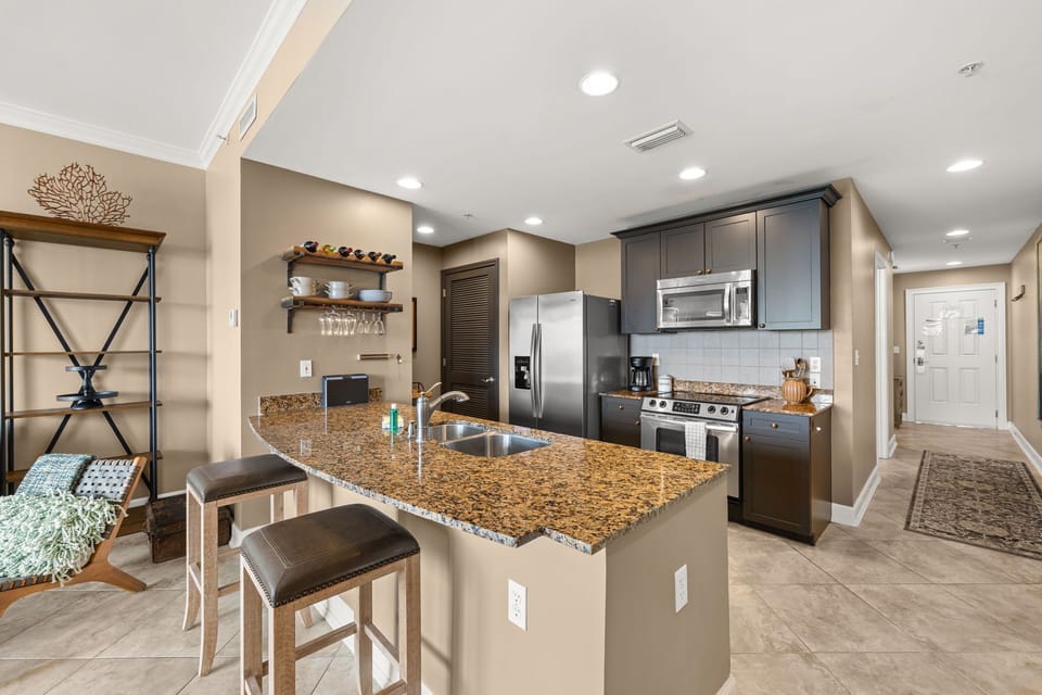 The fully equipped kitchen features granite countertops, stainless-steel appliances, and has everything you need to prepare meals for family & friends.