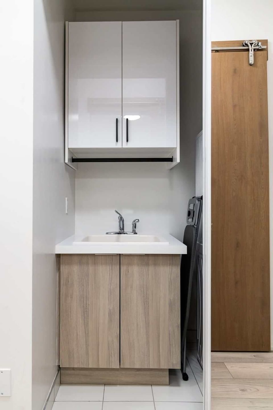 Compact utility sink area with storage cabinet