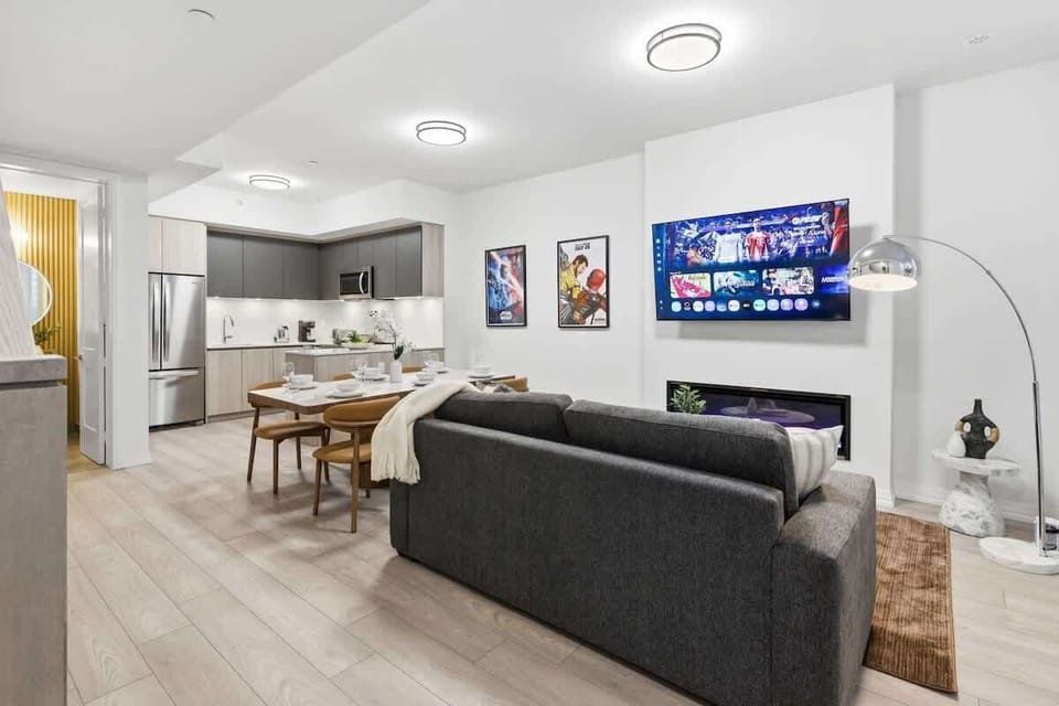 Modern living room with cozy seating, Smart TV, and sleek fireplace ambiance