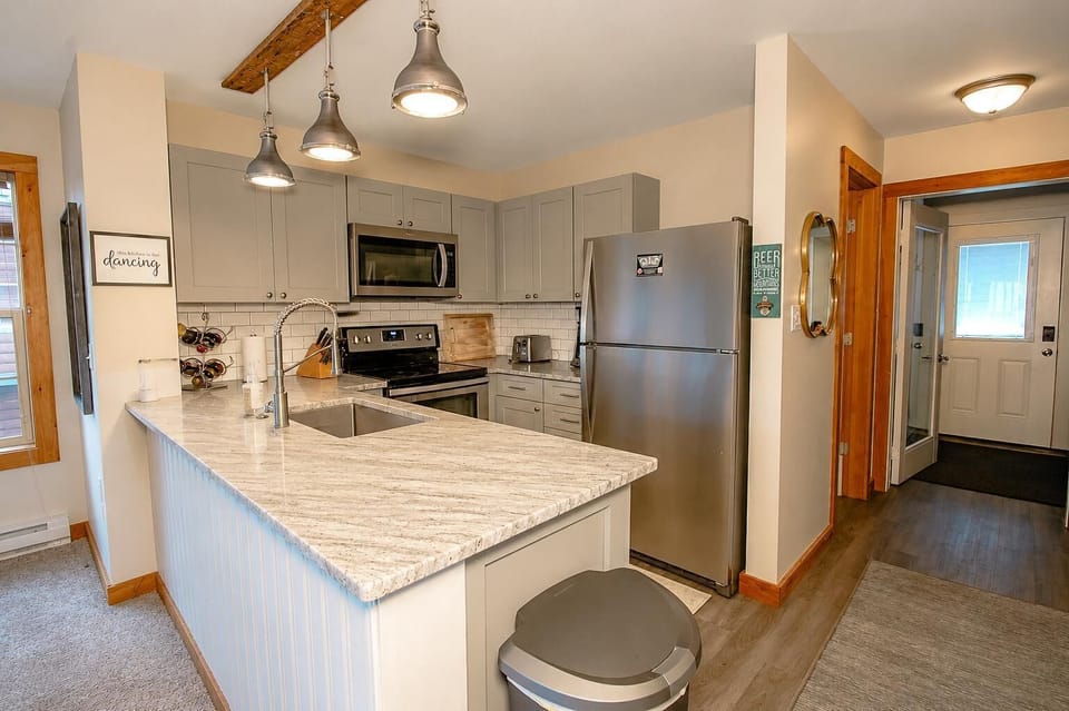 The kitchen, with stainless steel appliances and granite countertops, is perfect for preparing full meals or whipping up quick snacks between adventures.