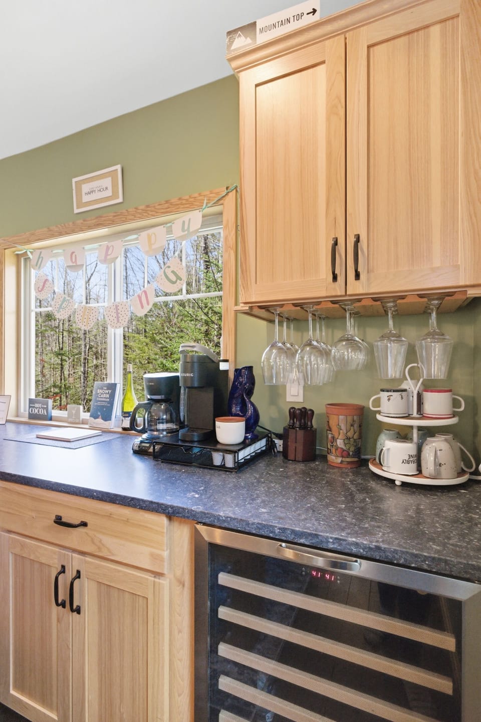 The coffee and beverage bar with Keurig, drip coffee maker, and built-in wine fridge — a good reason to take your time with mornings here.