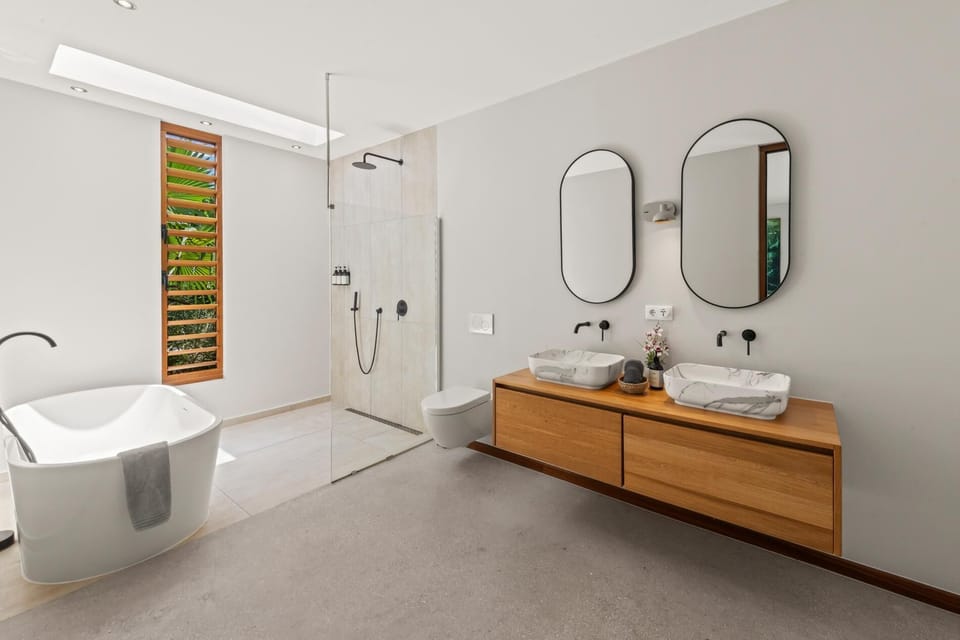 Modern ensuite bathroom with double vanity, walk-in rain shower and contemporary finishes.