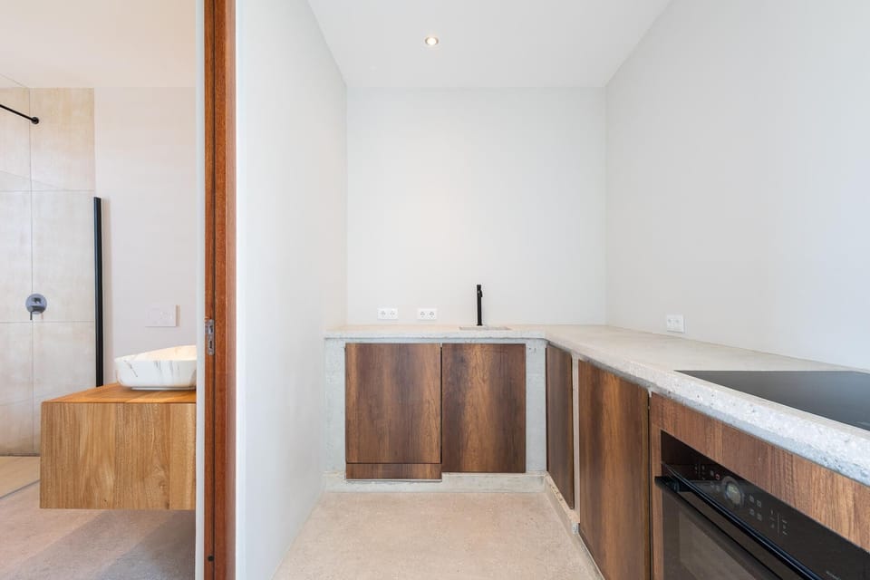 Private kitchenette in Bedroom 3 — timber cabinetry, cooktop and fridge for guests who want their own setup