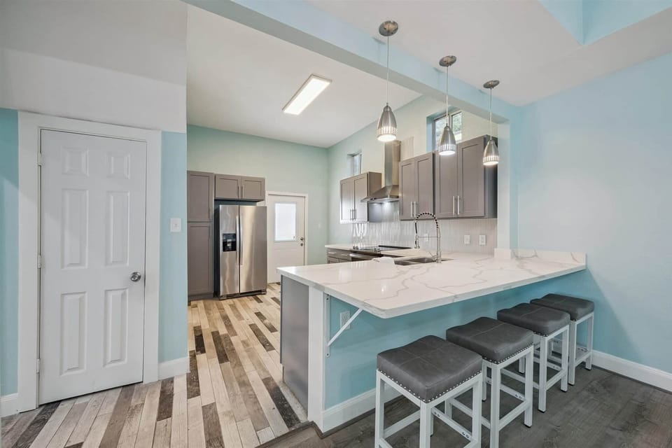 Bar with bar stools and kitchen 