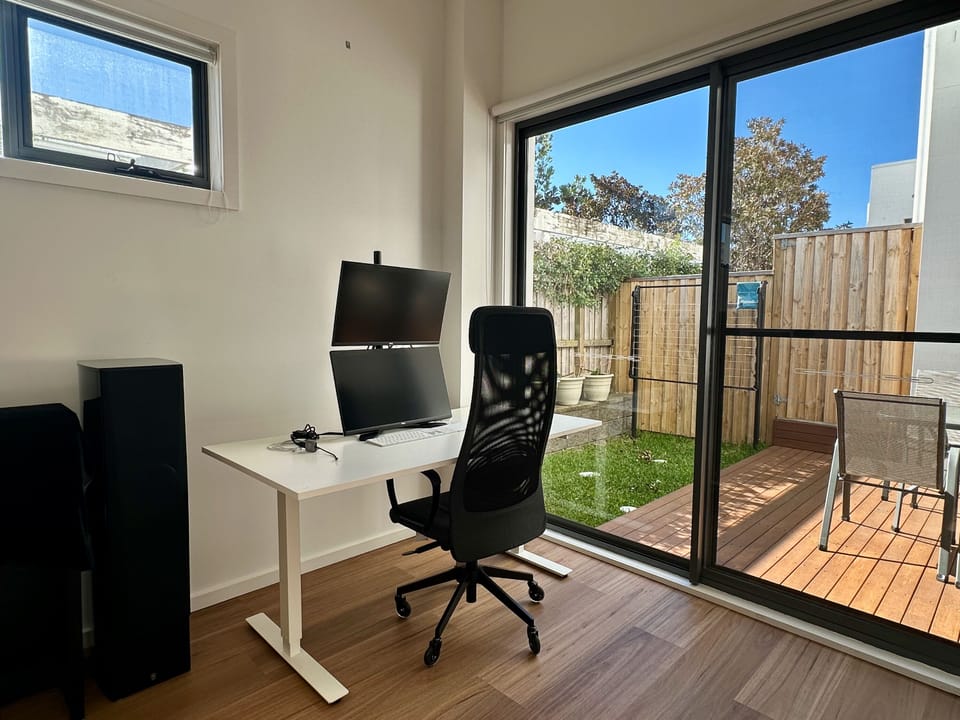 Bright home office with dual monitors and private courtyard access