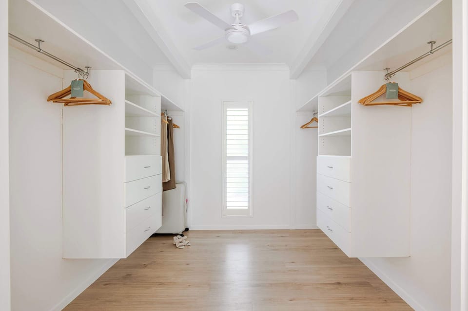 The generous walk-in wardrobe offers ample storage and an organised feel that makes longer stays feel like home.