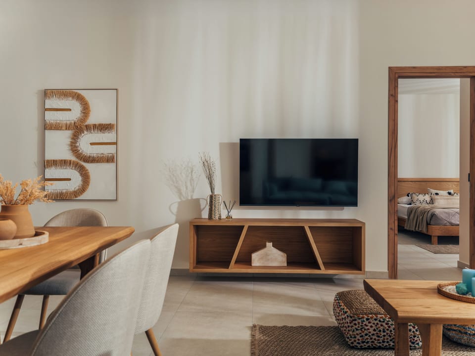Relax indoors with PS4 entertainment, JBL speaker, and graceful island style.