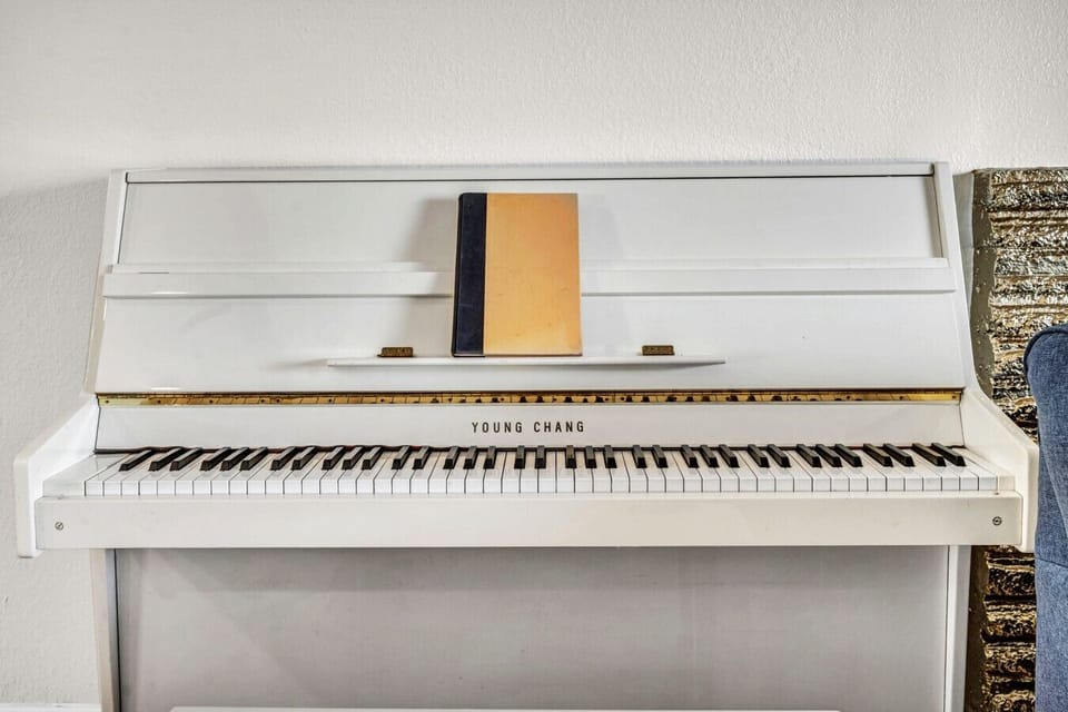 A beautiful piano that invites guests to slow down, play a favorite song, sing together, and turn a simple stay into a memorable moment.