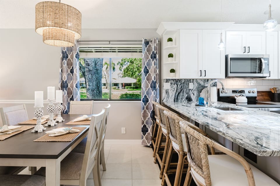 Bright open-concept living with dining for 6 and a fully upgraded kitchen featuring modern finishes, breakfast bar seating, and everything you need to cook and entertain
