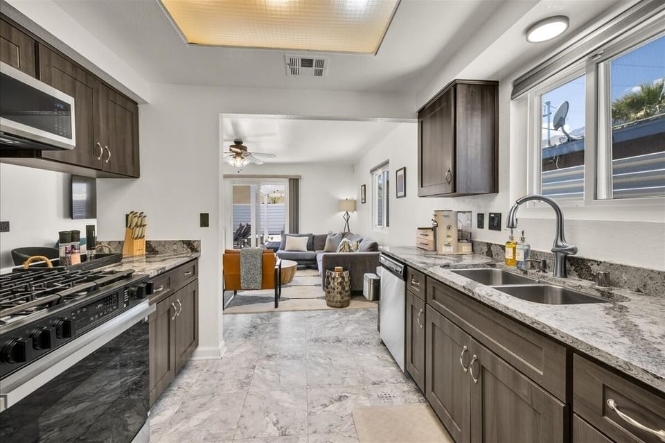 Bright chef's kitchen with updated finishes and backyard views