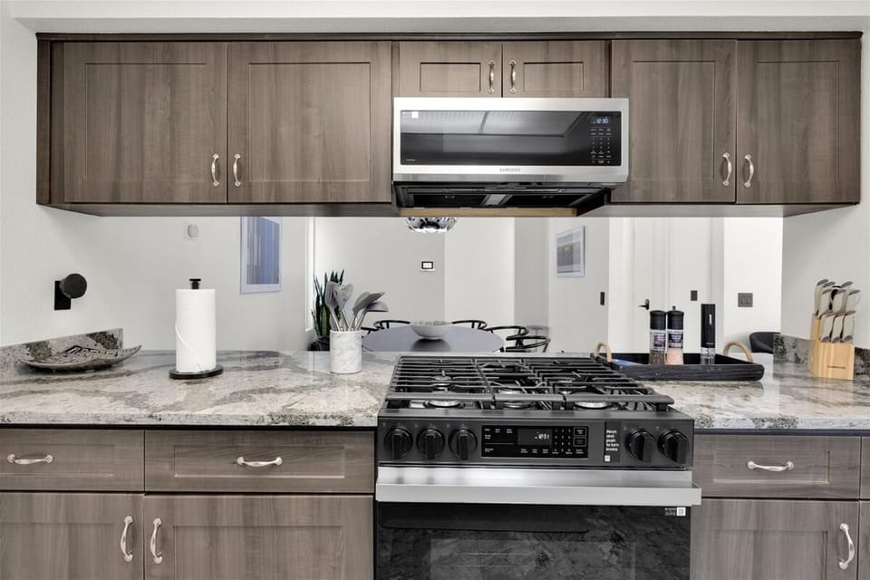 Modern kitchen with gas cooking and open dining connection