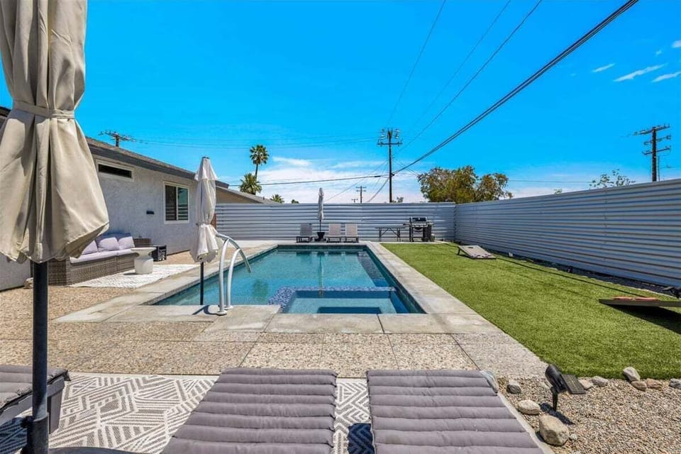 Private pool and spa with loungers, BBQ, and sunny yard space