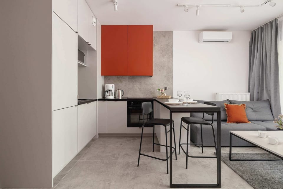 Bright open-plan studio featuring a kitchenette, dining space and relaxing lounge area.