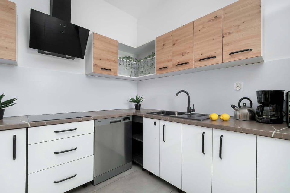 A close-up of the kitchen workspace with sink and stove. The design is clean and practical.