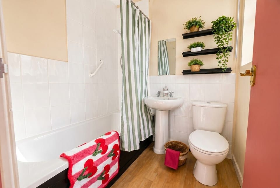Bath with overhead shower and playful plant shelves make mornings a little brighter.
