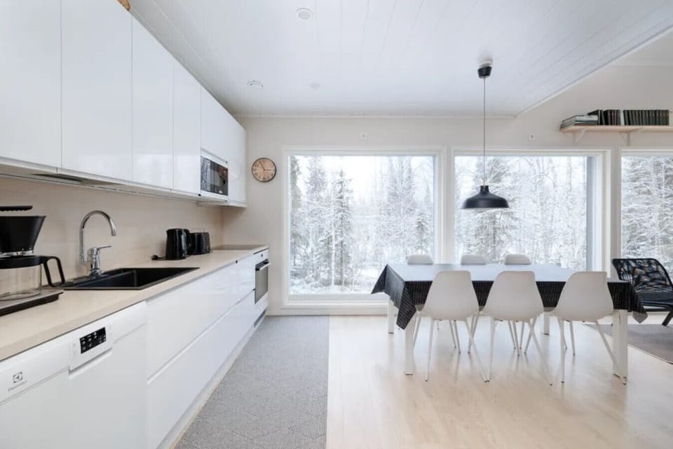 Prepare gourmet meals in our fully equipped modern kitchen while enjoying floor-to-ceiling views of the surrounding Lapland wilderness. The large dining table serves as the perfect hub for shared breakfasts before heading to the nearby slopes.