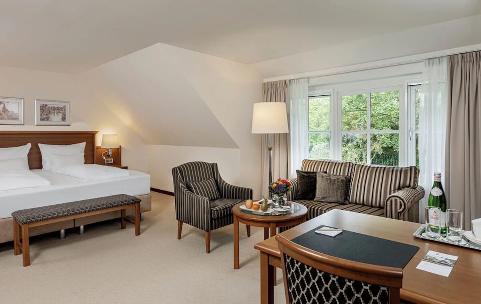 Unwind in a spacious suite with garden views and lounge seating